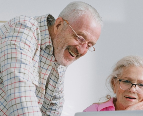 Retired couple behind laptop