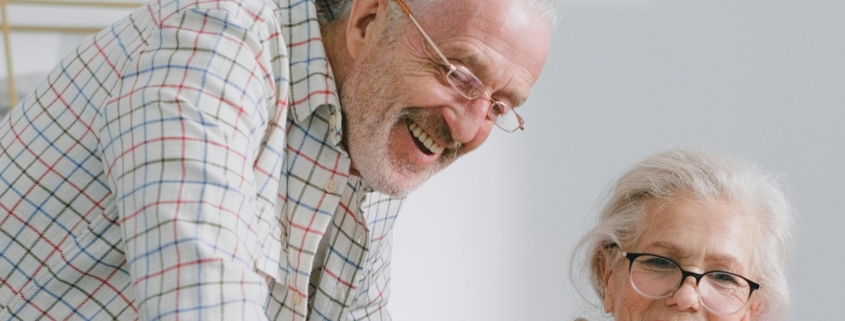 Retired couple behind laptop